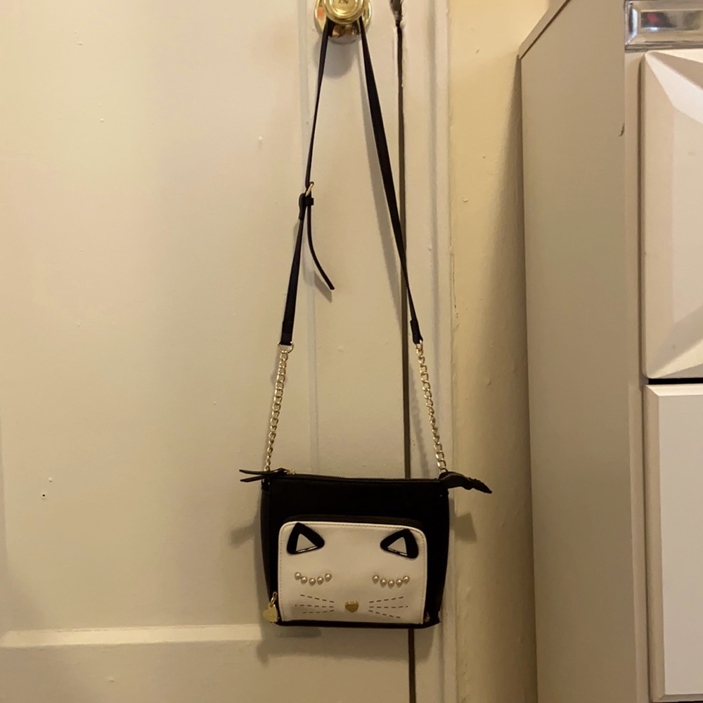 Small crossover bag with cat design in front.